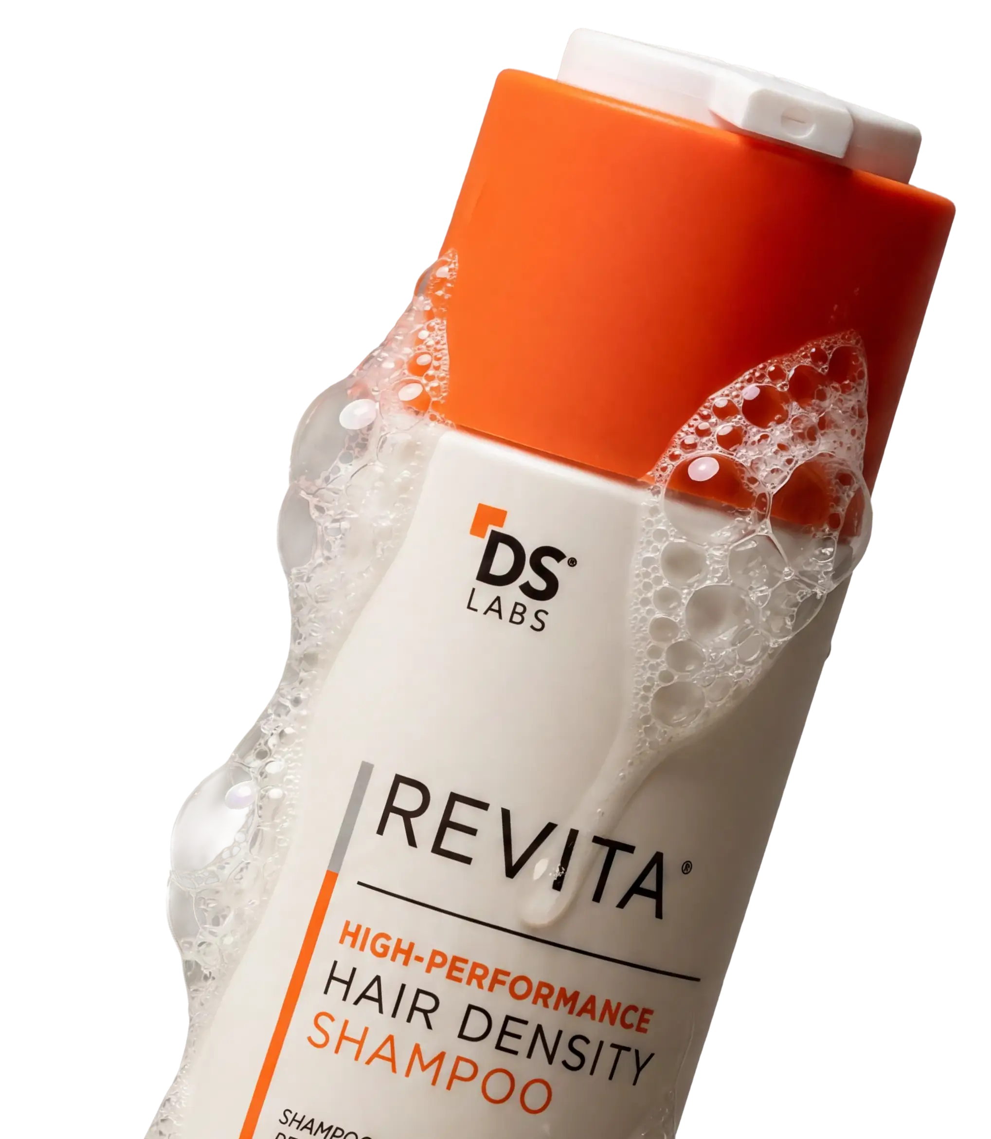 A close-up shot of a white and orange bottle of Revita shampoo covered in suds.
