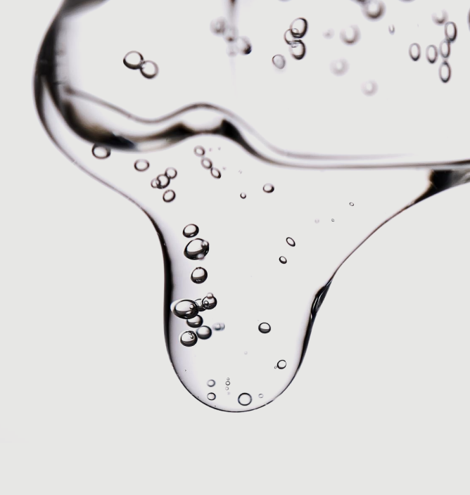 Clear gel with suspended bubbles against a white background.
