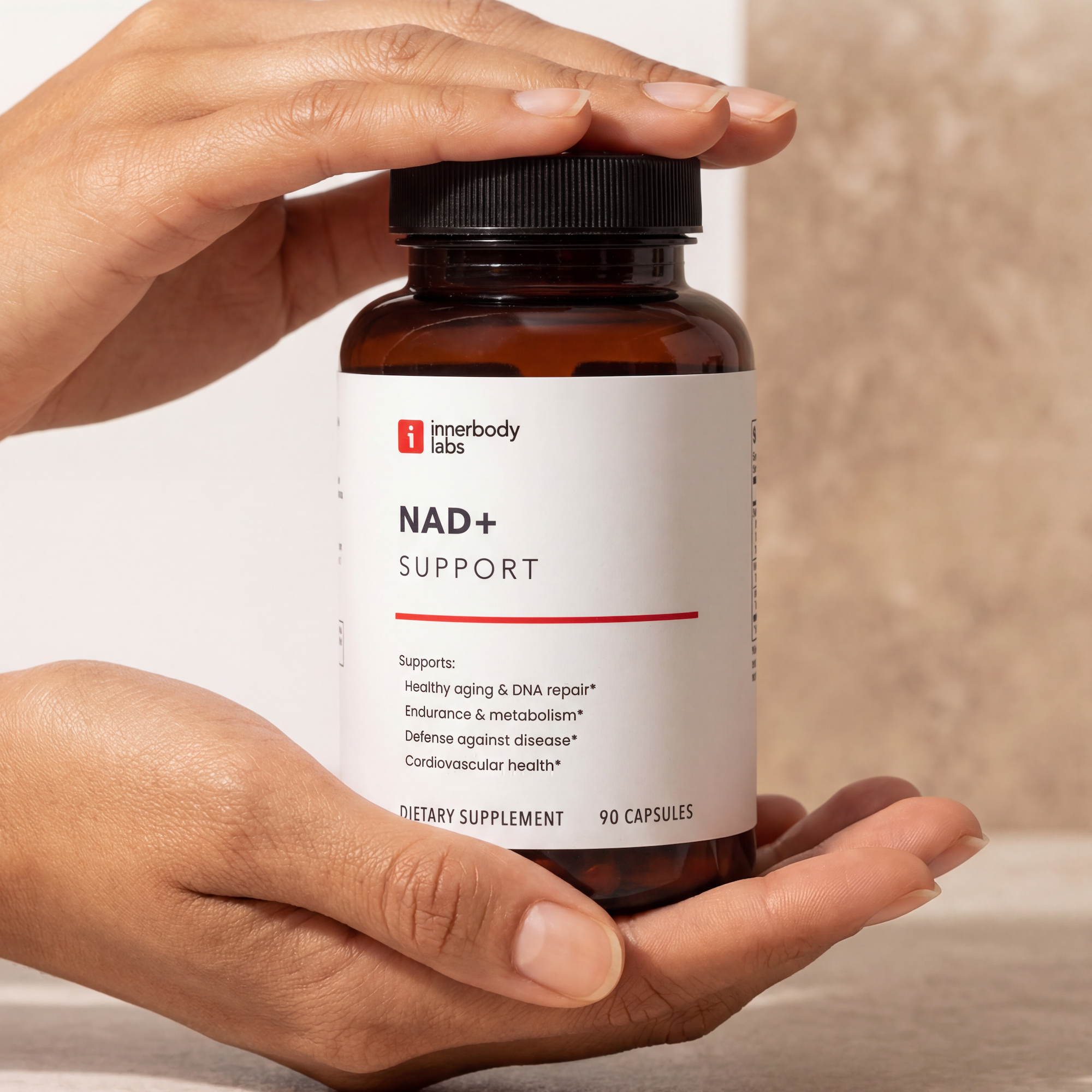 A hand holds a bottle of Innerbody Labs Testosterone Support supplement in a gym.