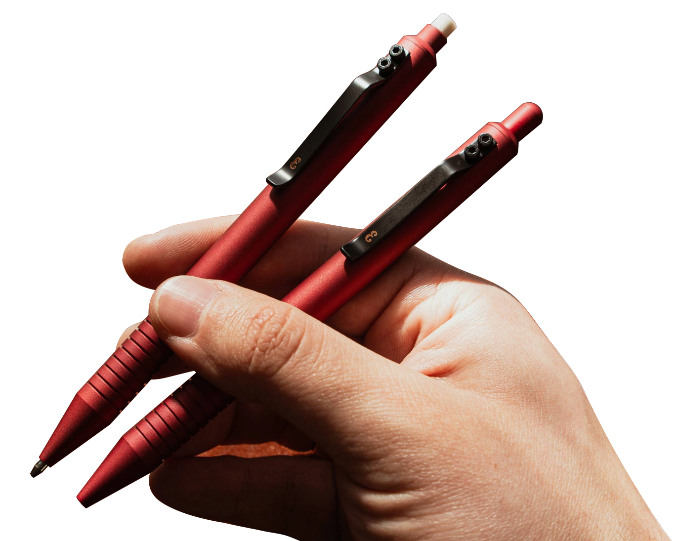 Hand holding two red pens with black clips.