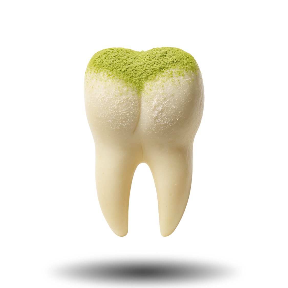 A realistic tooth sculpture with green powder on top.