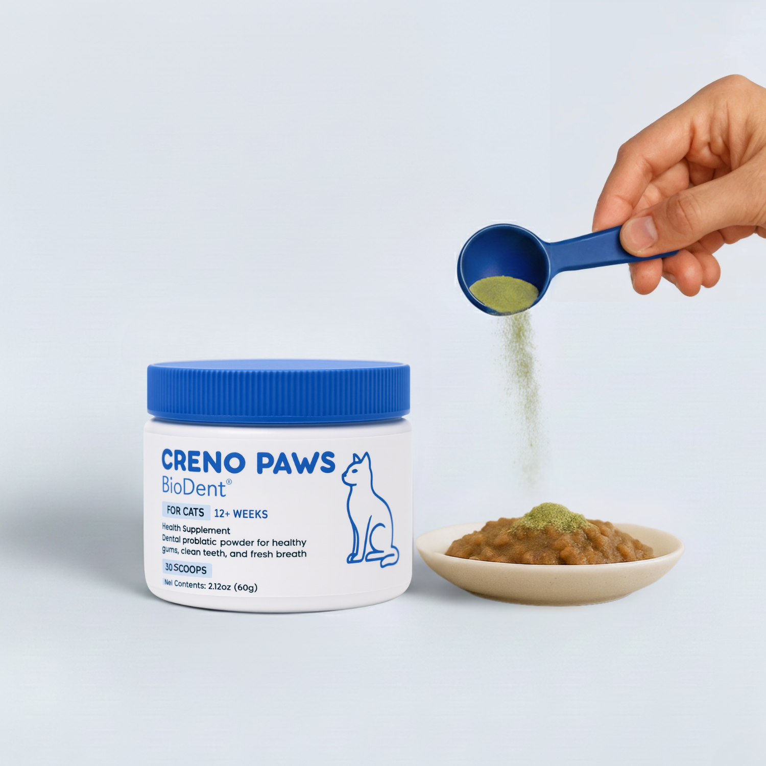 Hand sprinkling powder from blue scoop onto cat food, next to jar labeled 'CRENO PAWS BioDent.'