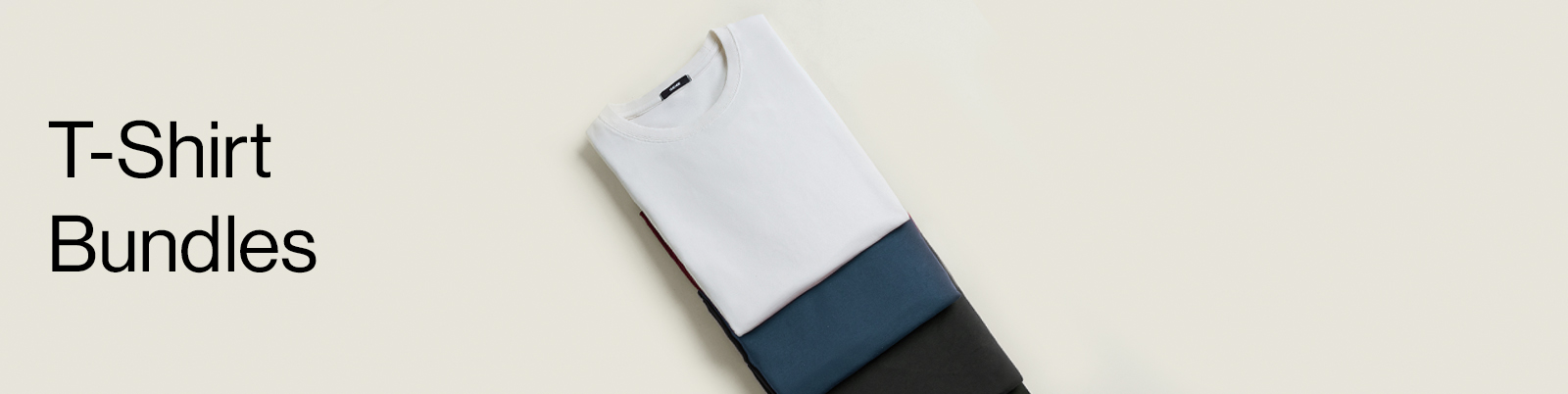 Three individuals in dark blue outfits standing in a dimly lit room.