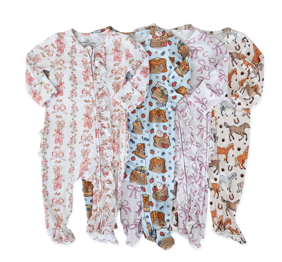 Five baby onesies with various colorful patterns.