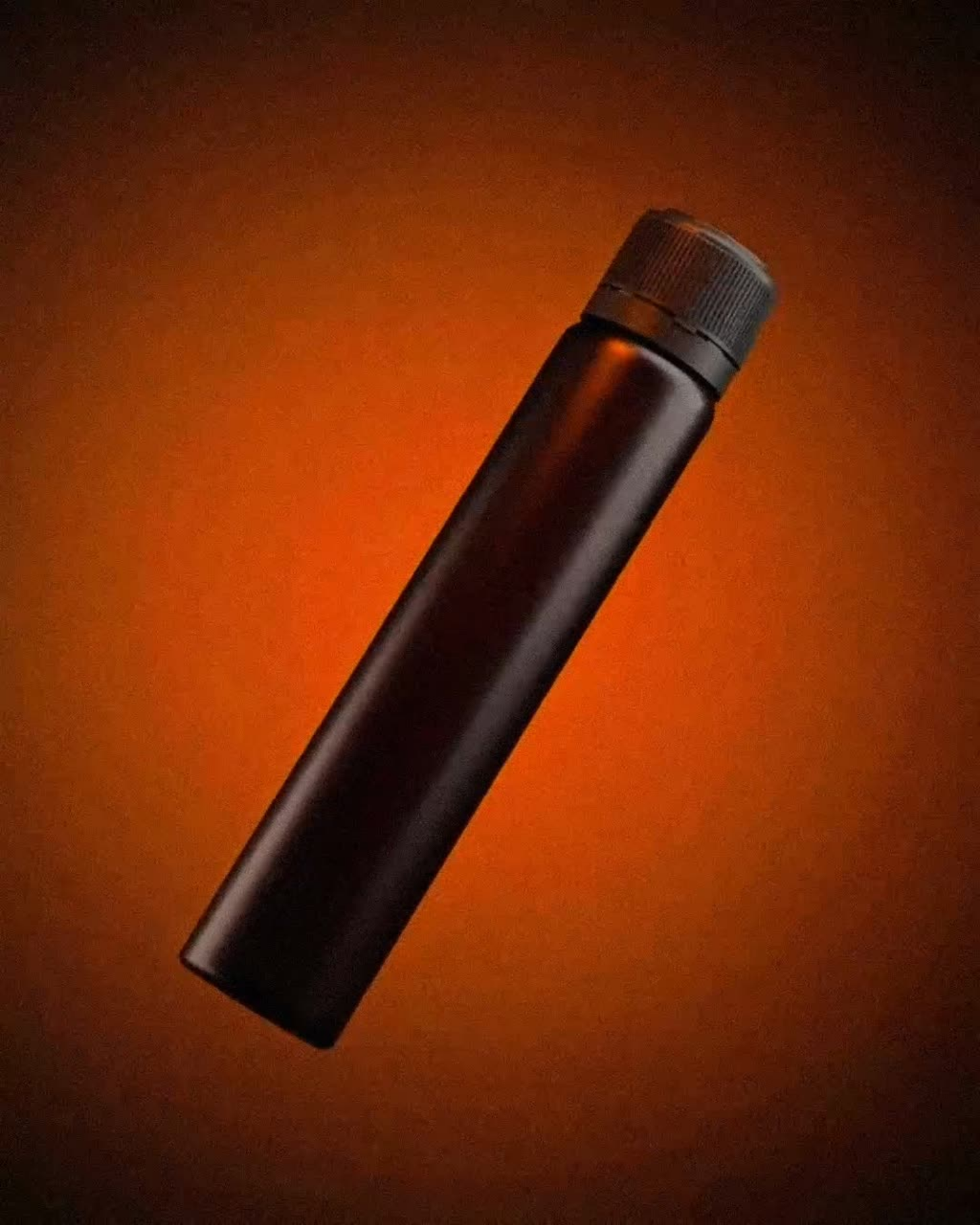 A black cylindrical bottle with a screw cap positioned diagonally on an orange gradient background.