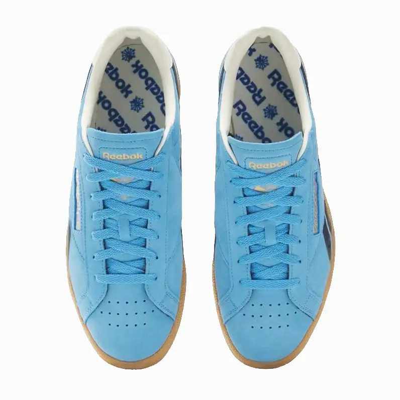 A top-down view of a pair of light blue Reebok sneakers with gum soles.
