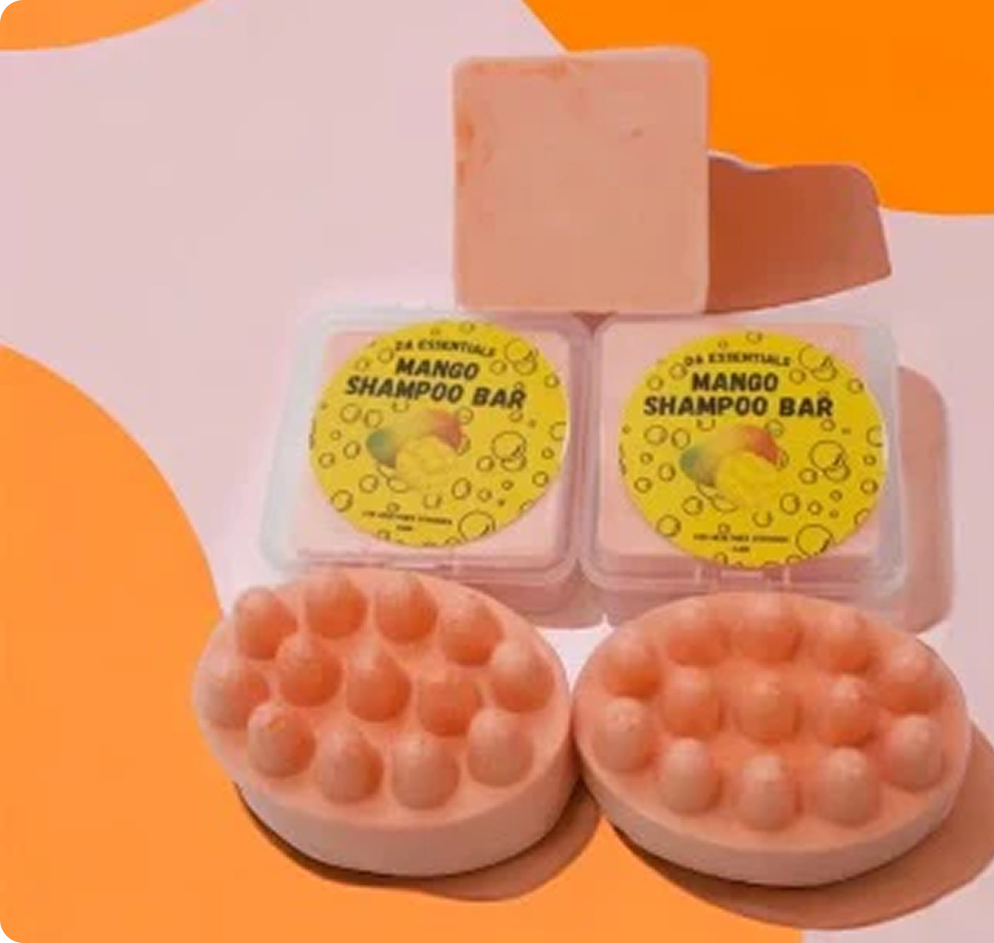 Mango shampoo bars with textured tops, labeled containers on an orange and white background.