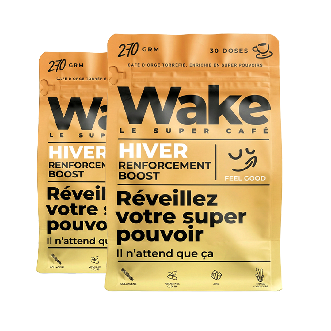 Two golden pouches of Wake Le Super Café, a roasted barley coffee product, against a white background.
