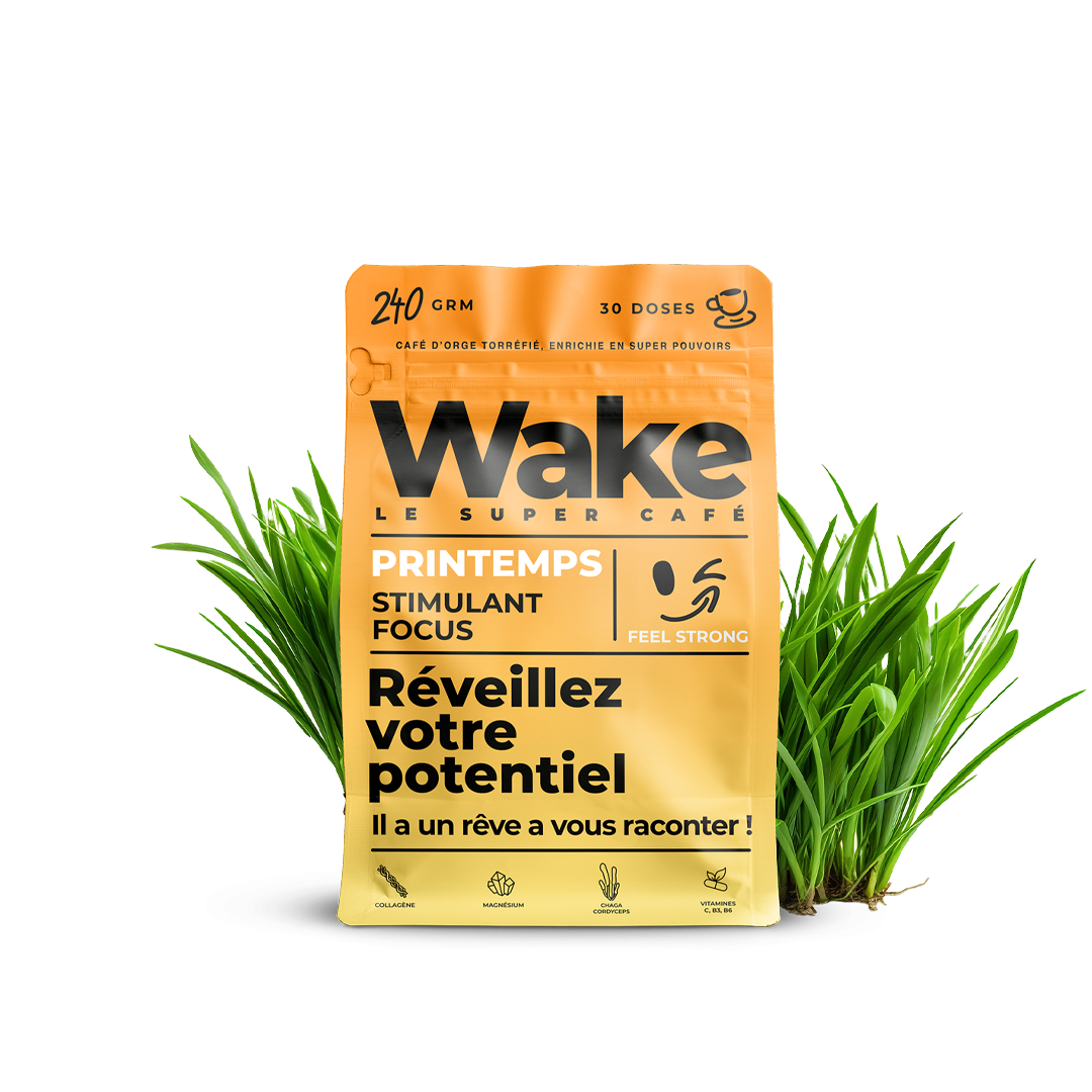 A yellow pouch of Wake Le Super Café, Printemps edition, nestled in bright green grass against a white background.