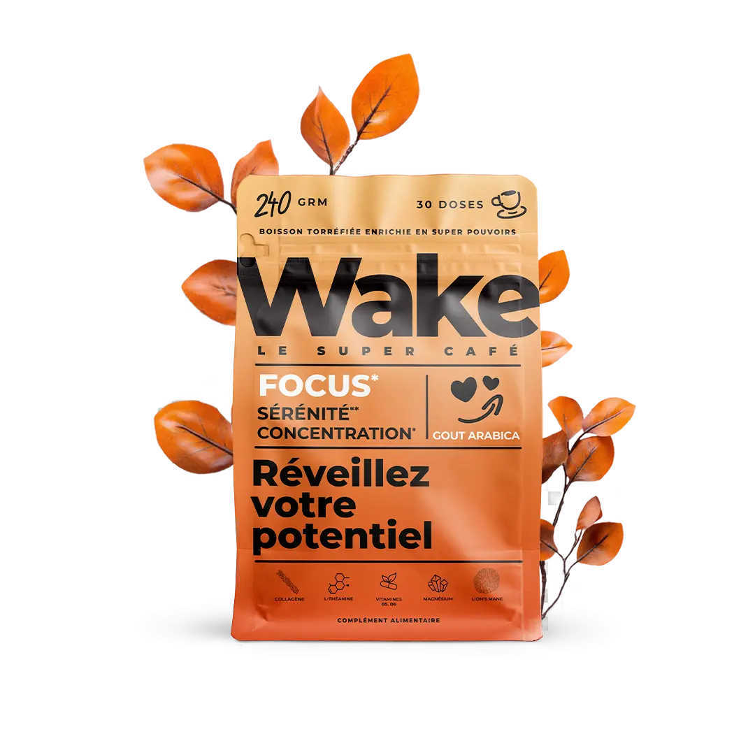 An orange pouch of Wake Le Super Café, a coffee dietary supplement, surrounded by orange leaves.