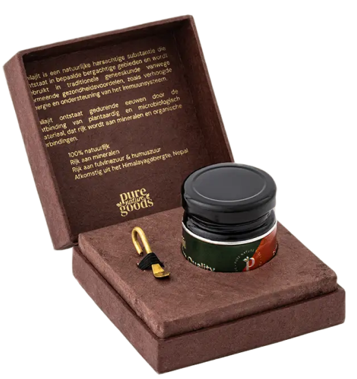 Open box with a jar and a small tool inside, text on the lid.