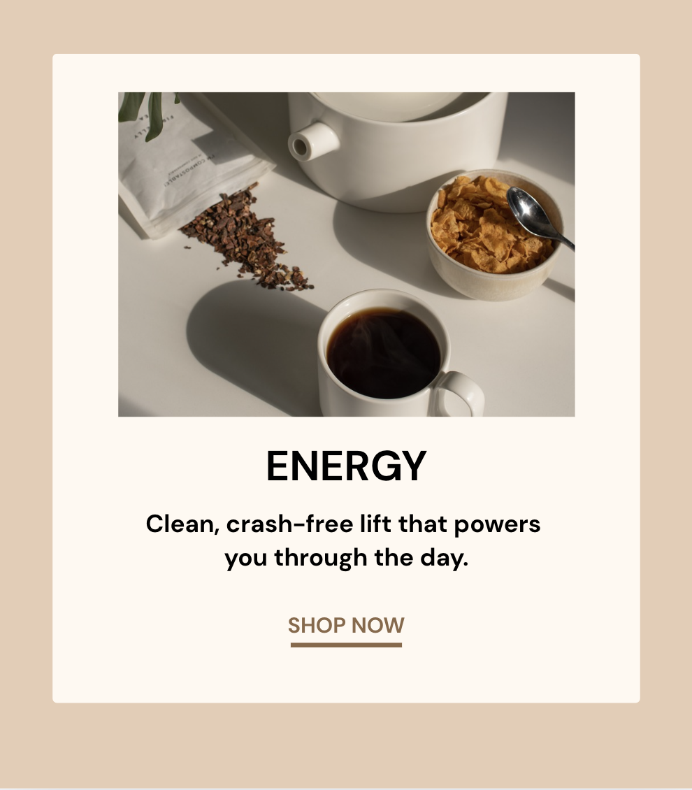 Coffee cup, cereal bowl, and spilled granola on a white table.