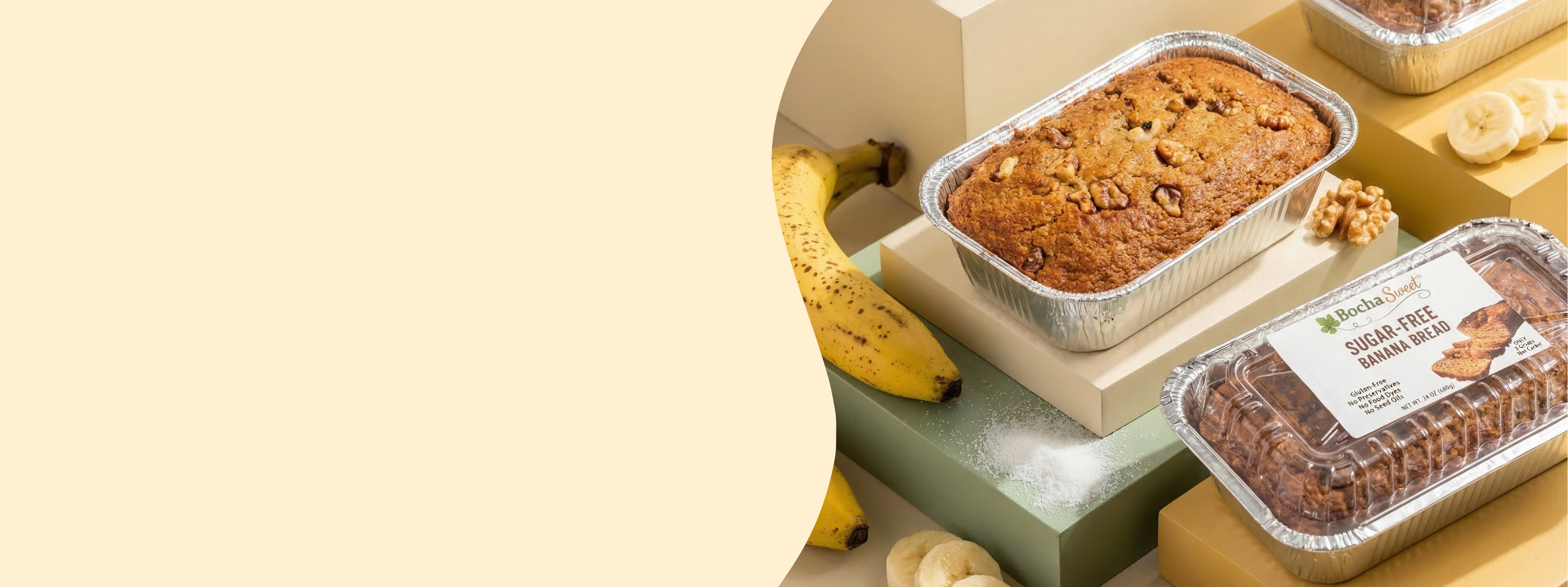 Loaves of sugar-free banana bread displayed with fresh bananas, walnuts, and sweetener on colored blocks.
