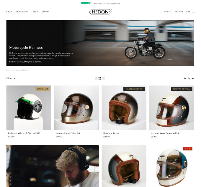 Webpage displaying various motorcycle helmets with a banner image of a person riding a motorcycle.