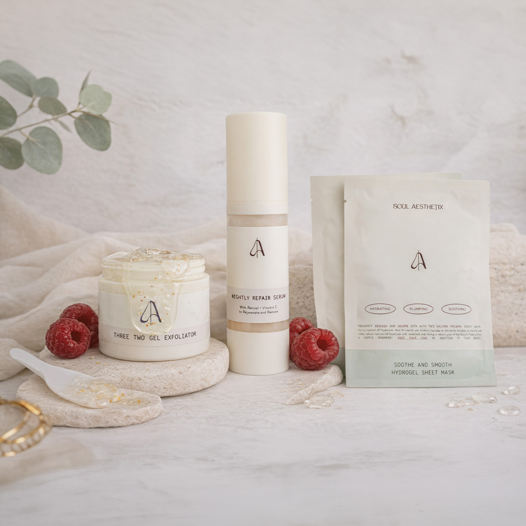 A collection of skincare products, including a gel exfoliator, serum, and sheet mask, arranged with fresh raspberries.