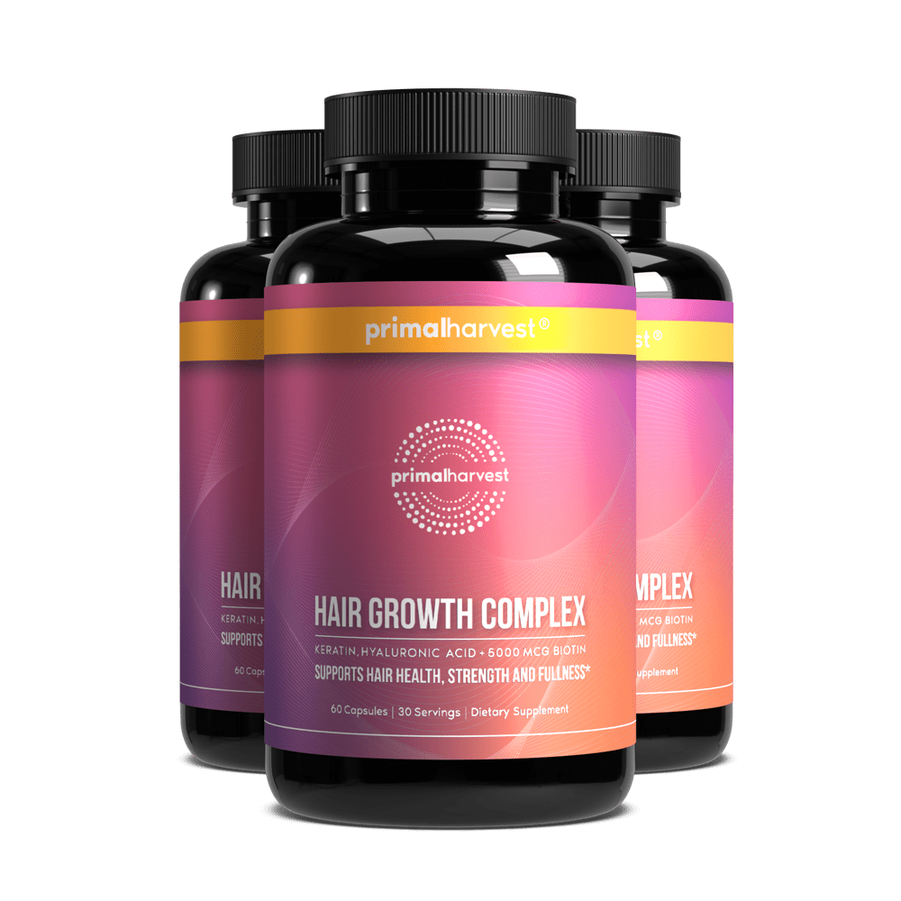 Three bottles of Primal Harvest Hair Growth Complex dietary supplement against a solid dark green background.
