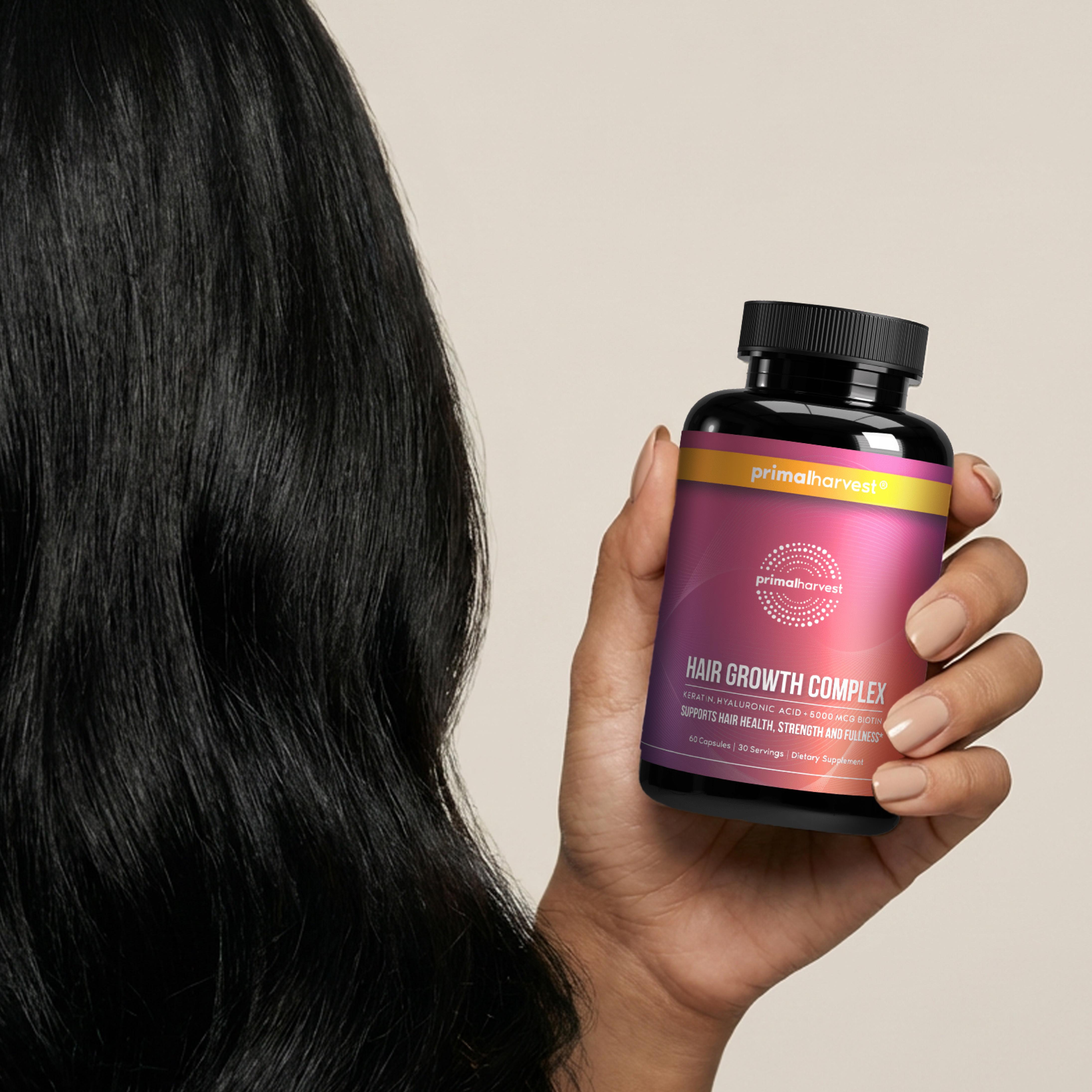 A woman with long, black hair holds a bottle of Primal Harvest Hair Growth Complex supplements.