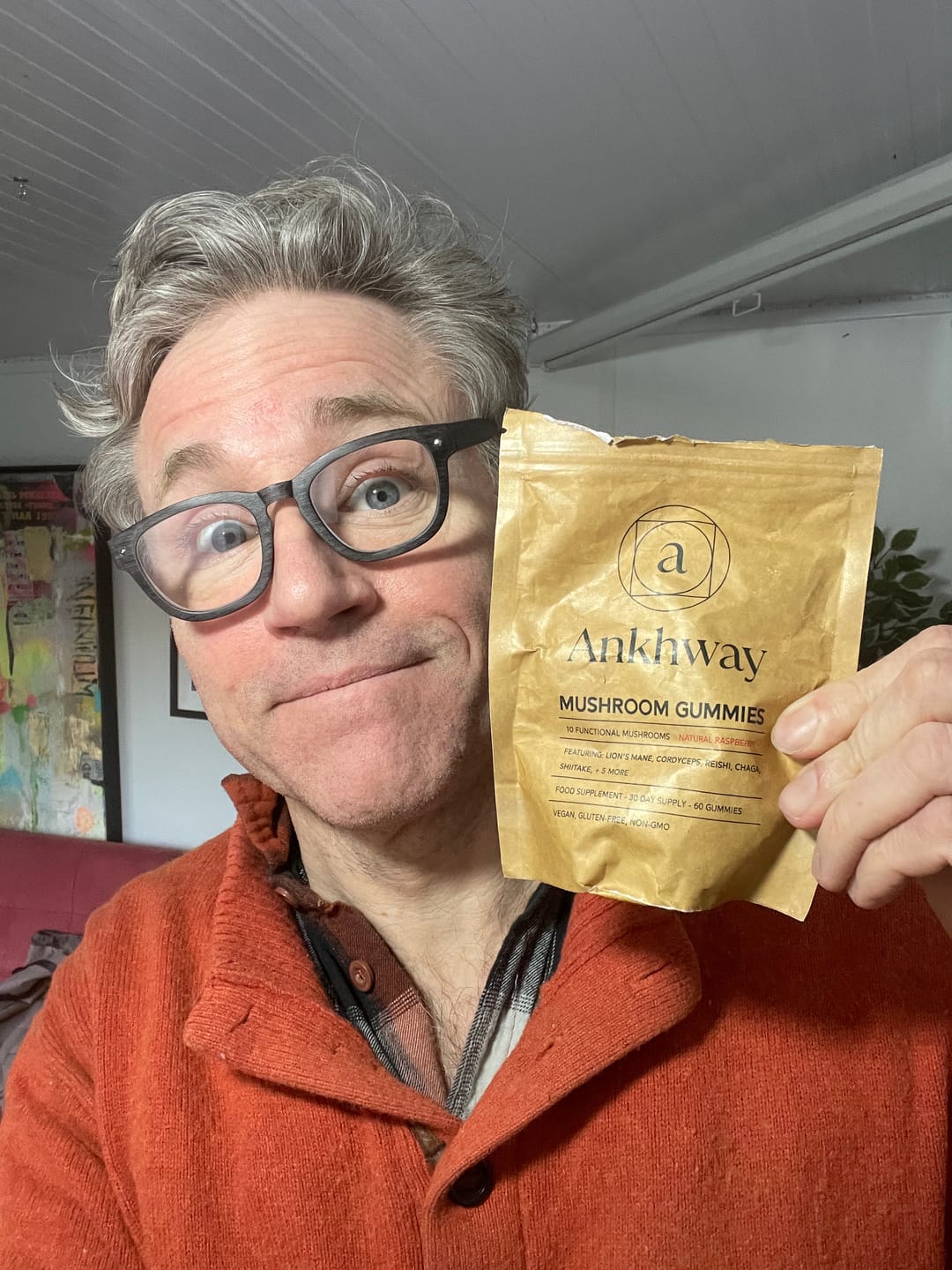 Person holding a packet of Ankhway mushroom gummies.