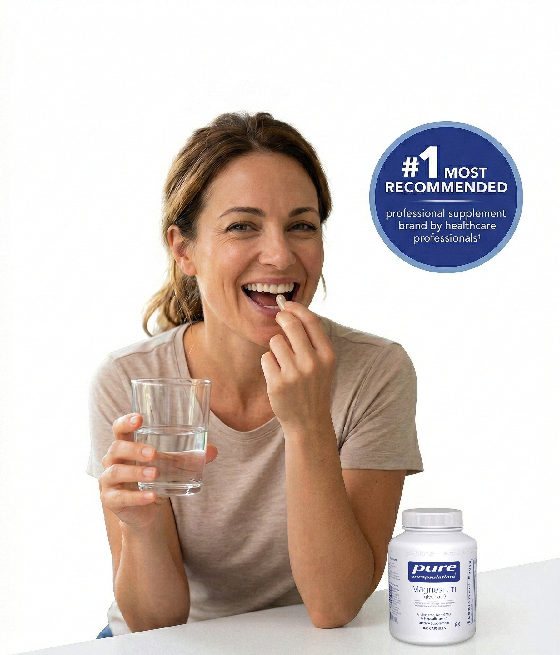 A smiling woman takes a supplement capsule with a glass of water, next to a bottle of magnesium.