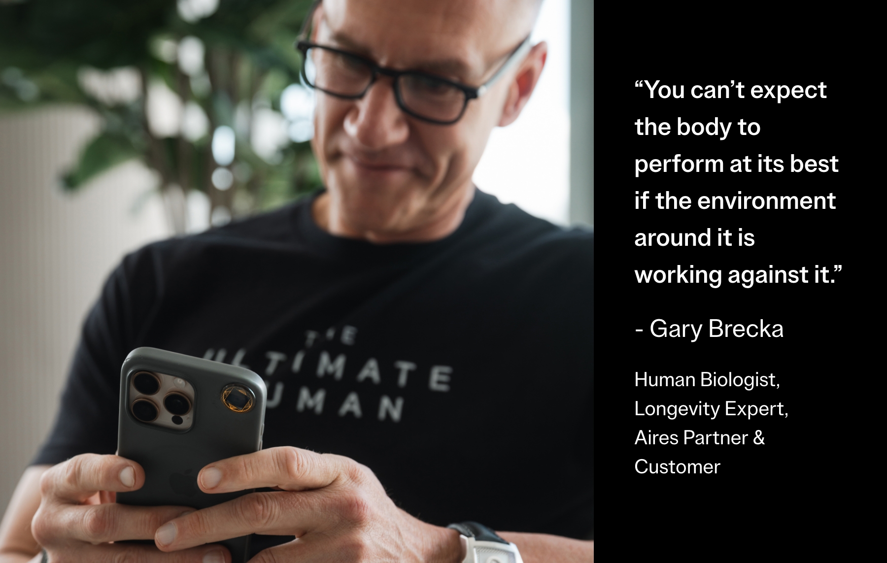 A man in glasses smiles while looking at his phone next to a quote from Gary Brecka.