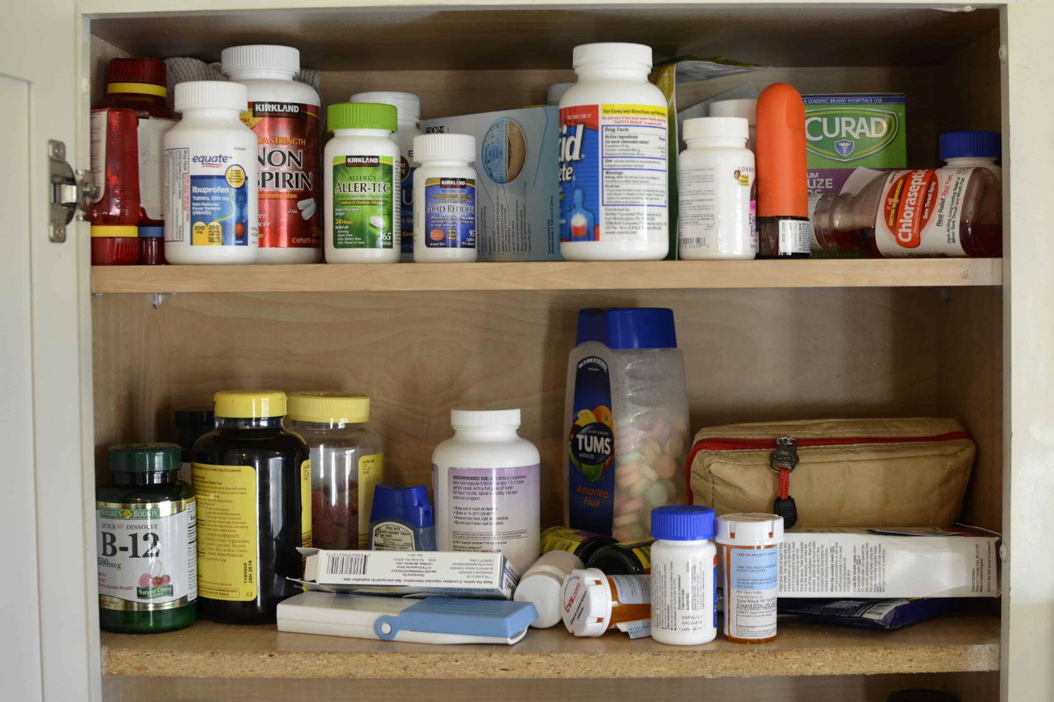 A cabinet filled with various medicine bottles and containers.