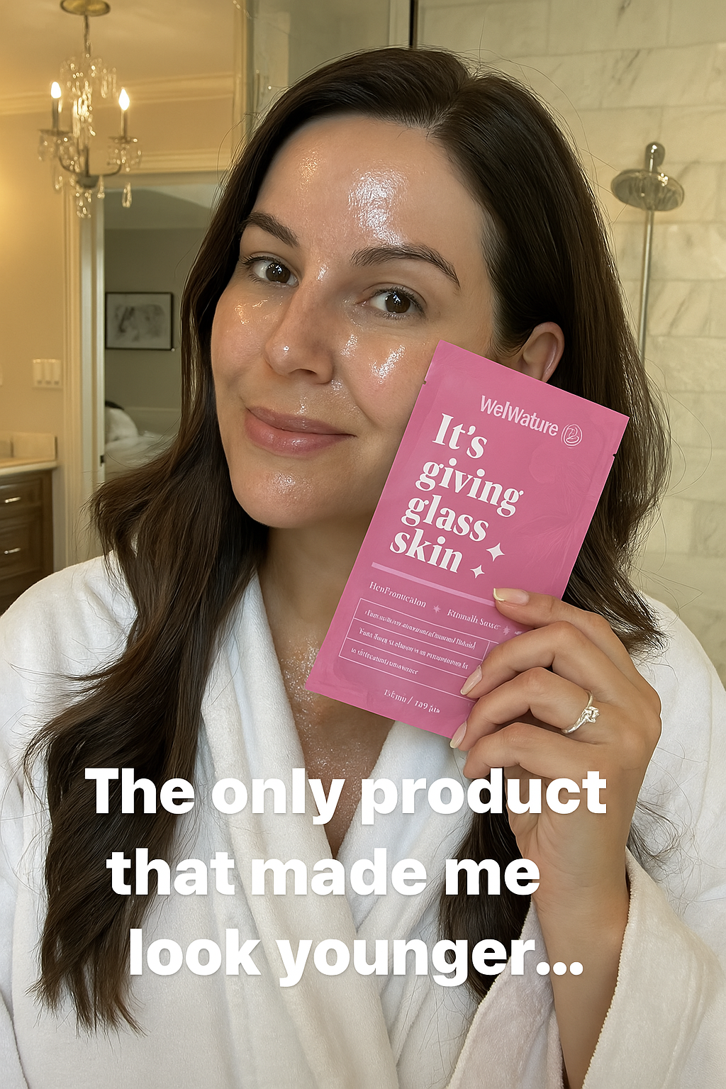 Person holding a skincare product package in a bathroom, wearing a white robe.