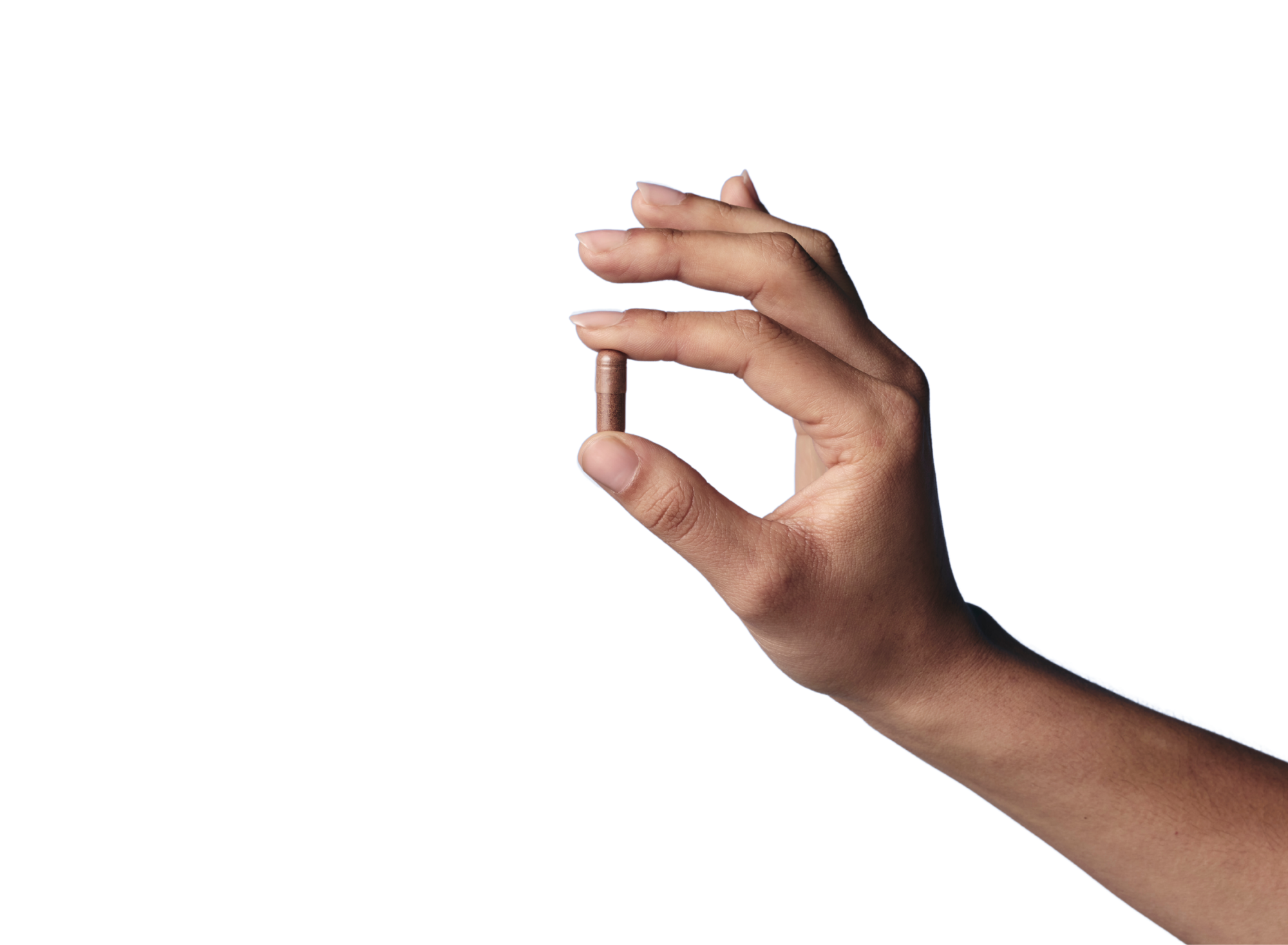 A hand holds a single brown capsule between its thumb and forefinger against a black background.
