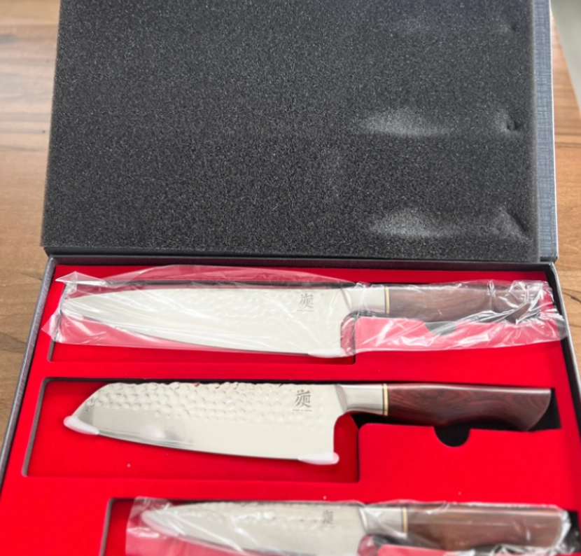 Set of three kitchen knives in a red and black box.