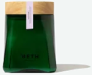 A dark green glass jar with a wooden lid and the word HETH printed on its front.