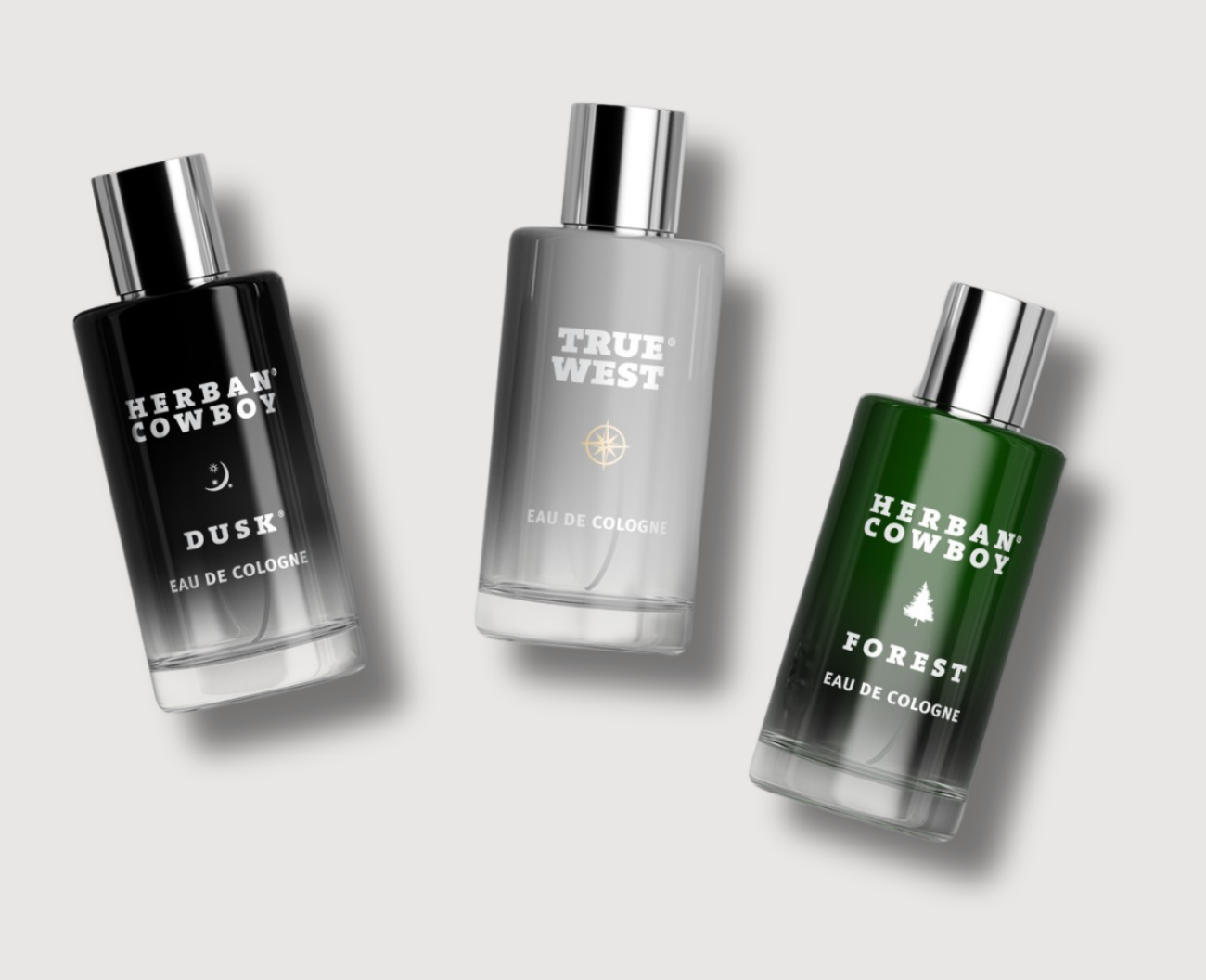 Three cologne bottles labeled Dusk, True West, and Forest.