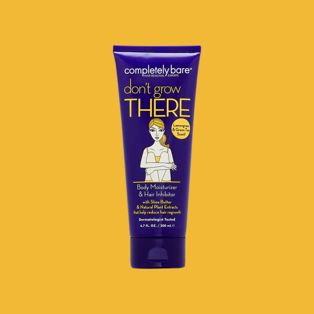 A purple tube of Completely Bare Don't Grow There Body Moisturizer & Hair Inhibitor on a yellow background.
