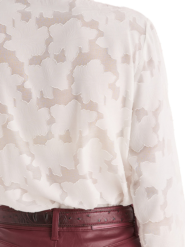 White floral-patterned blouse with maroon belt.