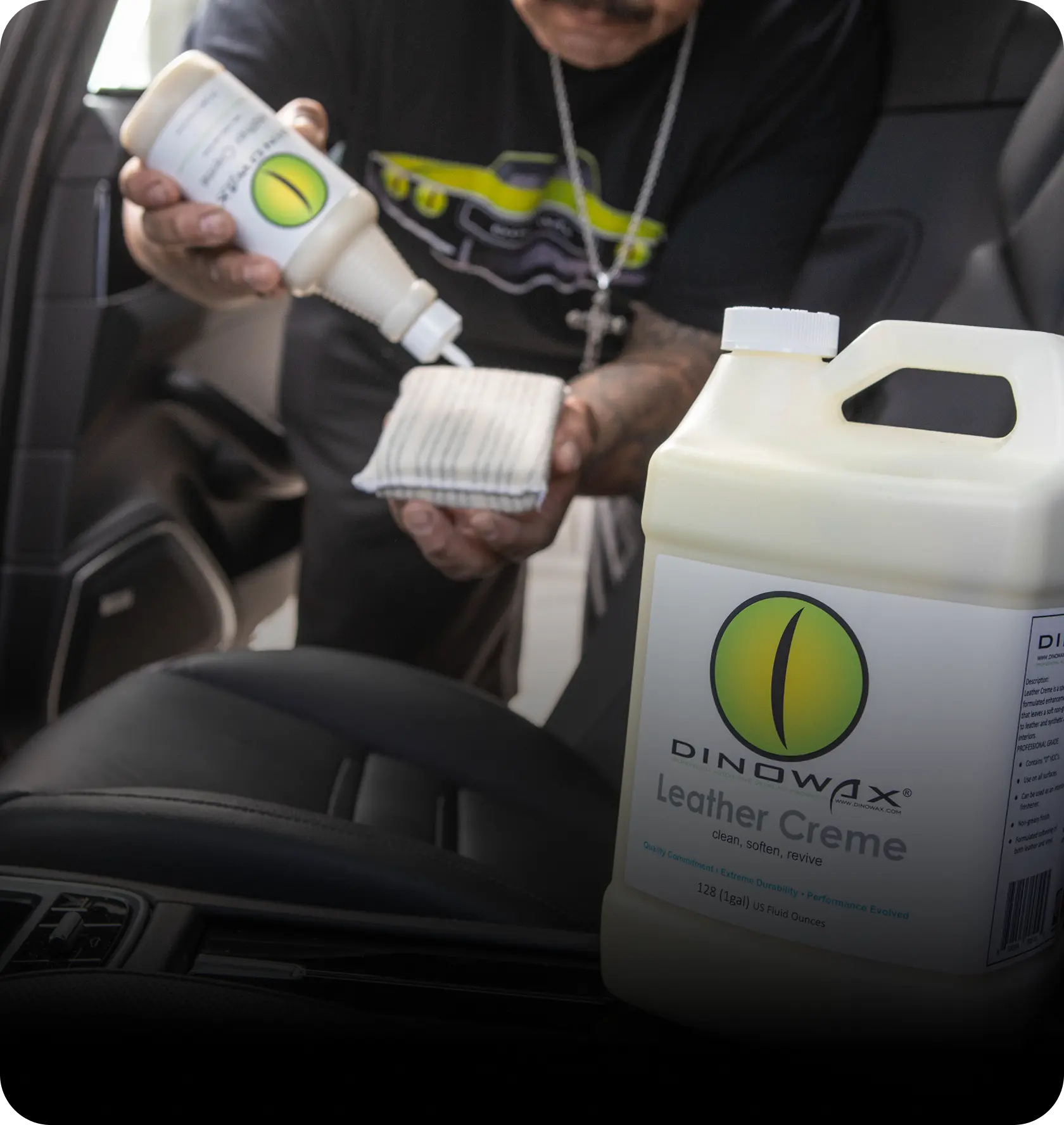 Person applying leather creme to a car seat with a cloth.