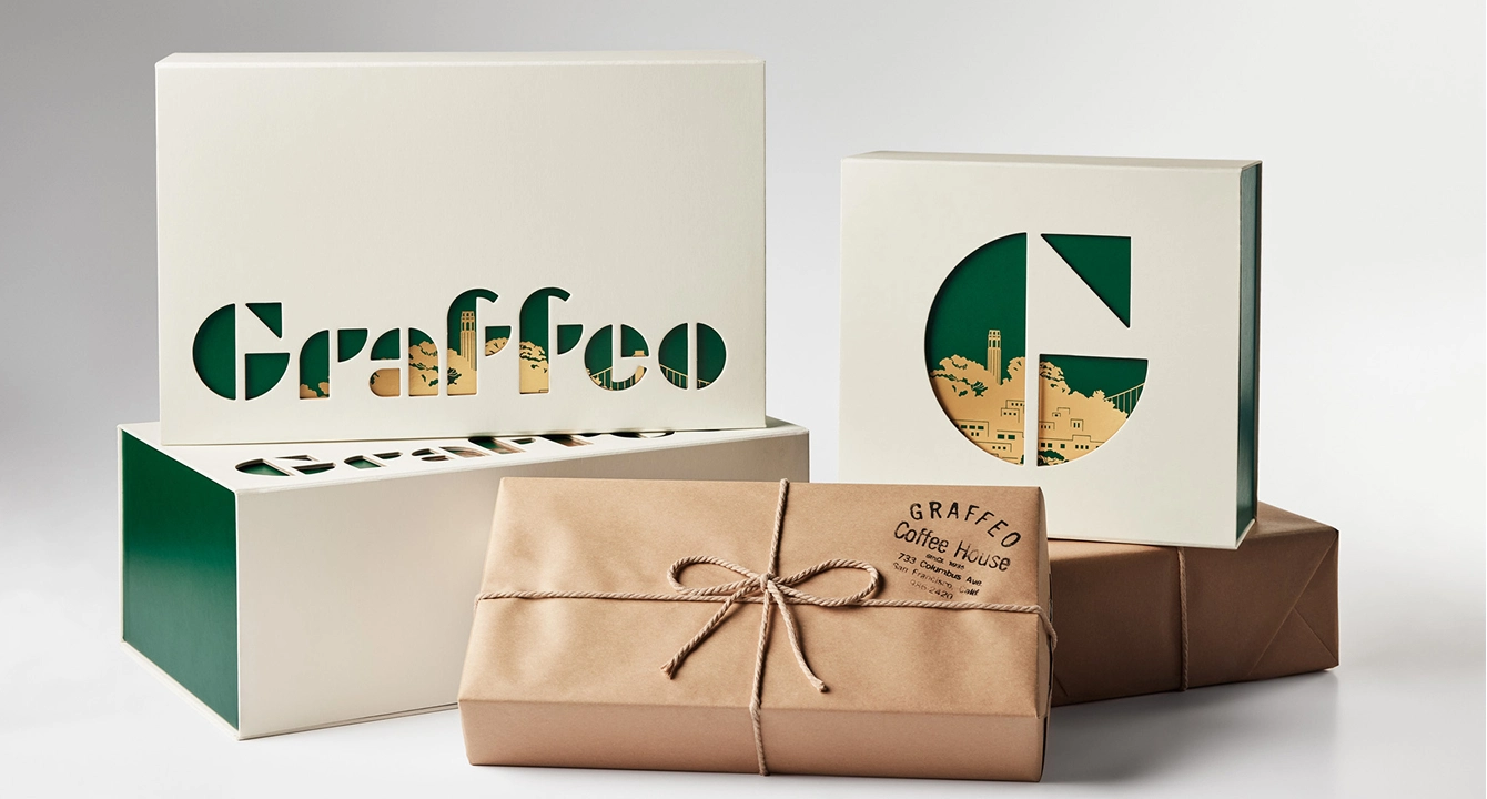 A collection of branded Graffeo Coffee House packaging with intricate cut-out box designs and a paper-wrapped parcel.
