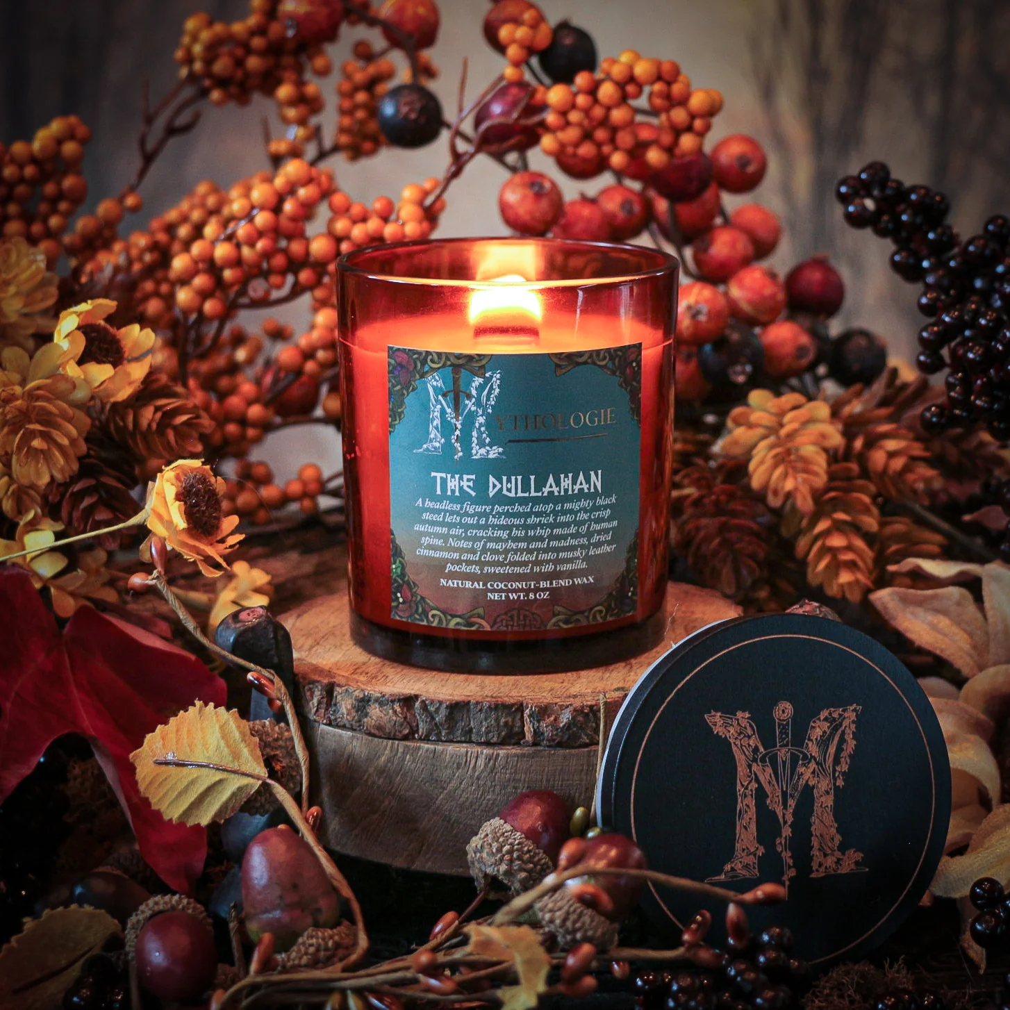Lit candle labeled 'The Dullahan,' surrounded by autumn-themed decorations.