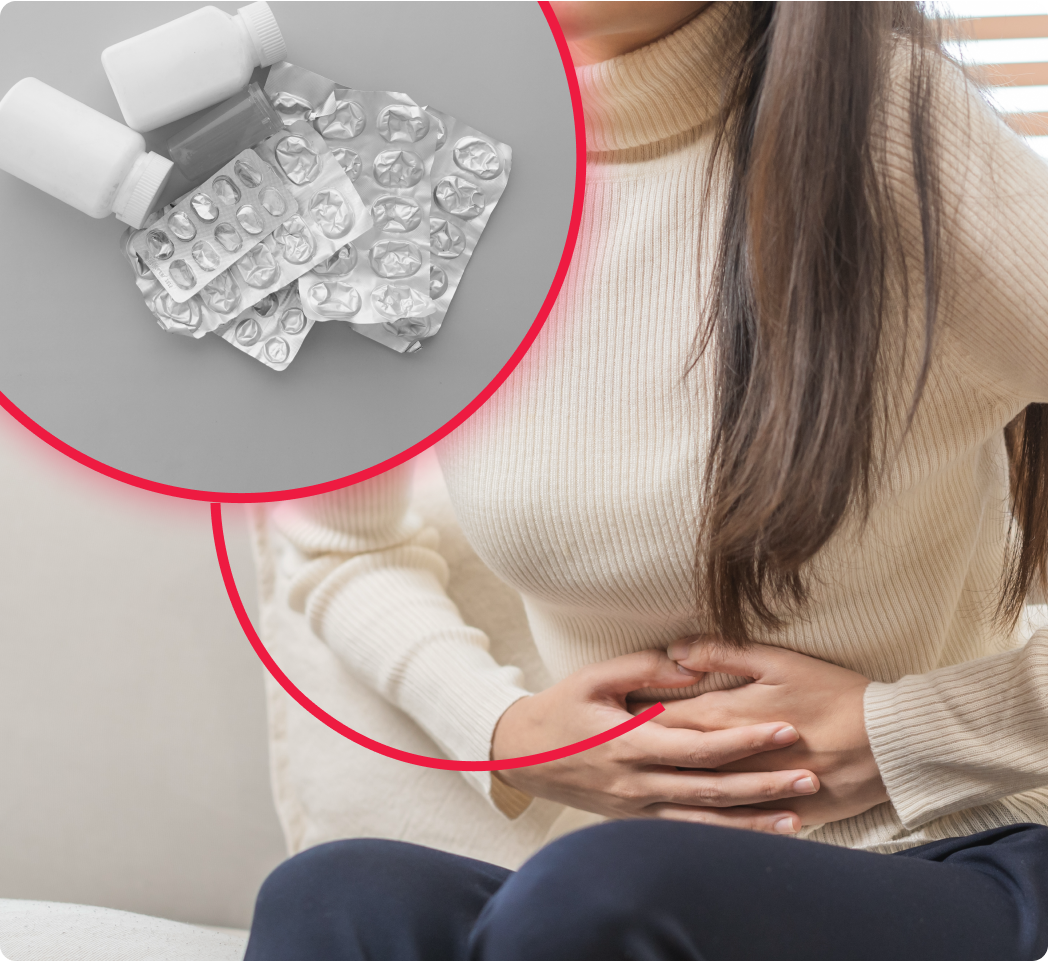 Woman holding stomach with empty pill blister packs inset.