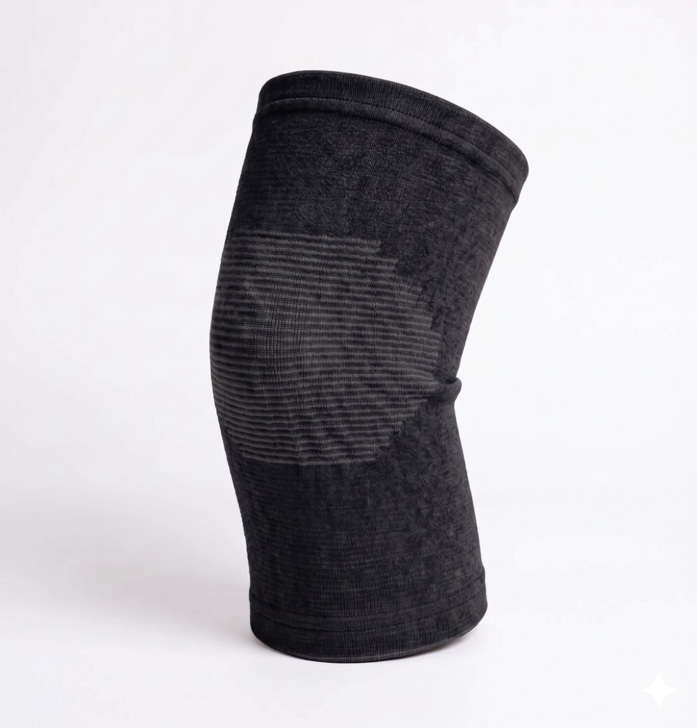 A black elastic knee support sleeve with textured fabric, against a white background.