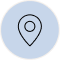 A black line art icon of a map pin on a light blue circular background.