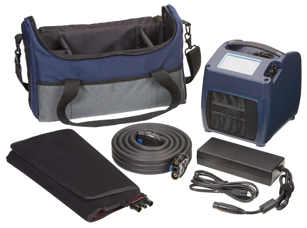 A medical therapy device kit with a console, wrap, hose, power supply, and carrying bag.