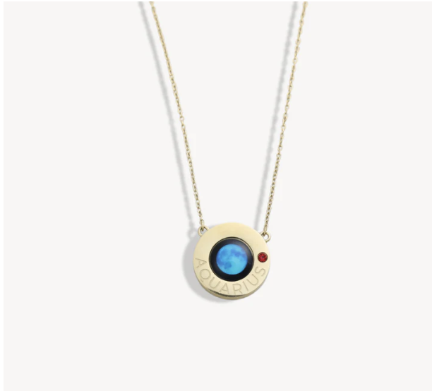 Gold necklace with a round pendant featuring a blue center and 'Aquarius' engraved.