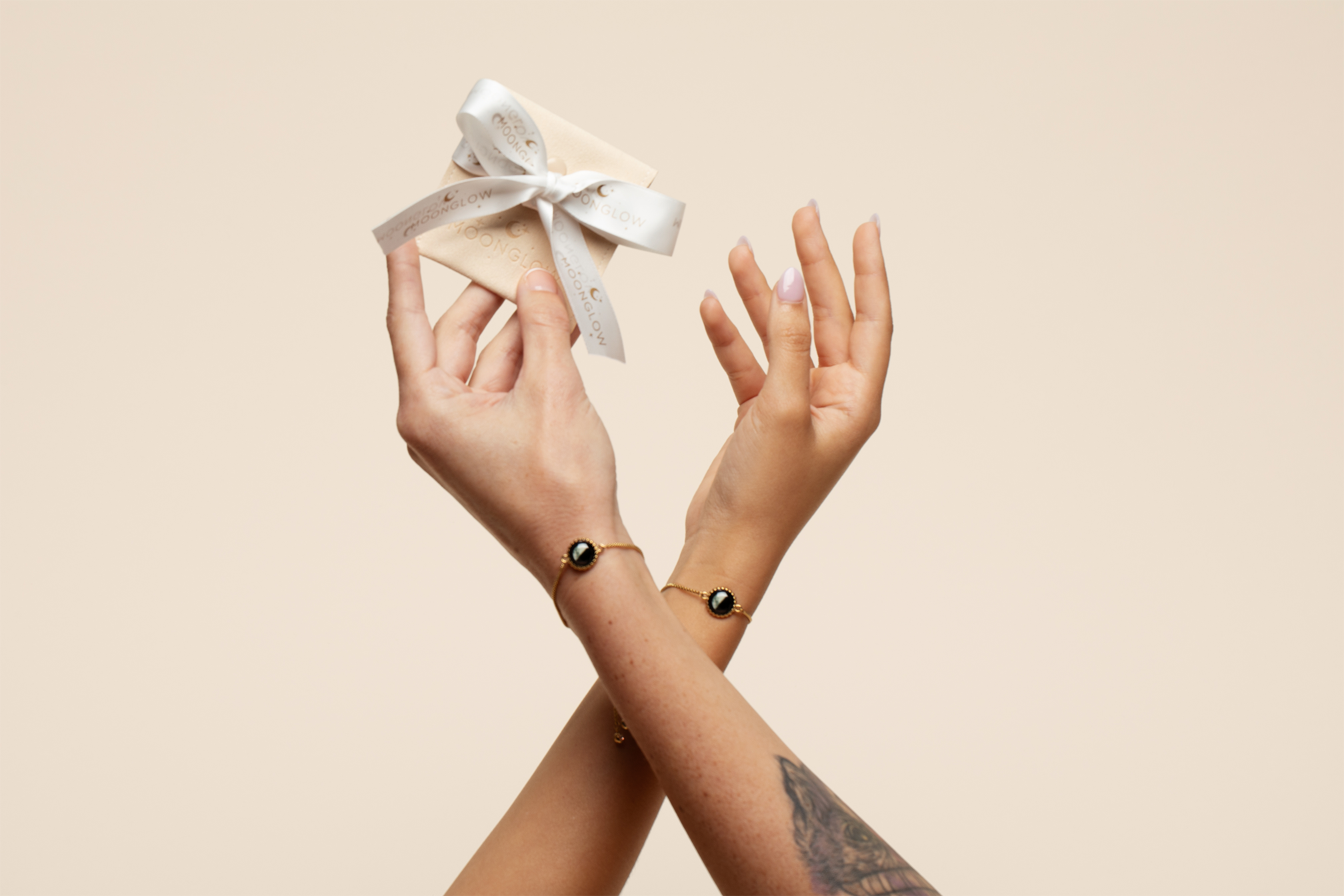 Two hands holding a small gift box with a ribbon.