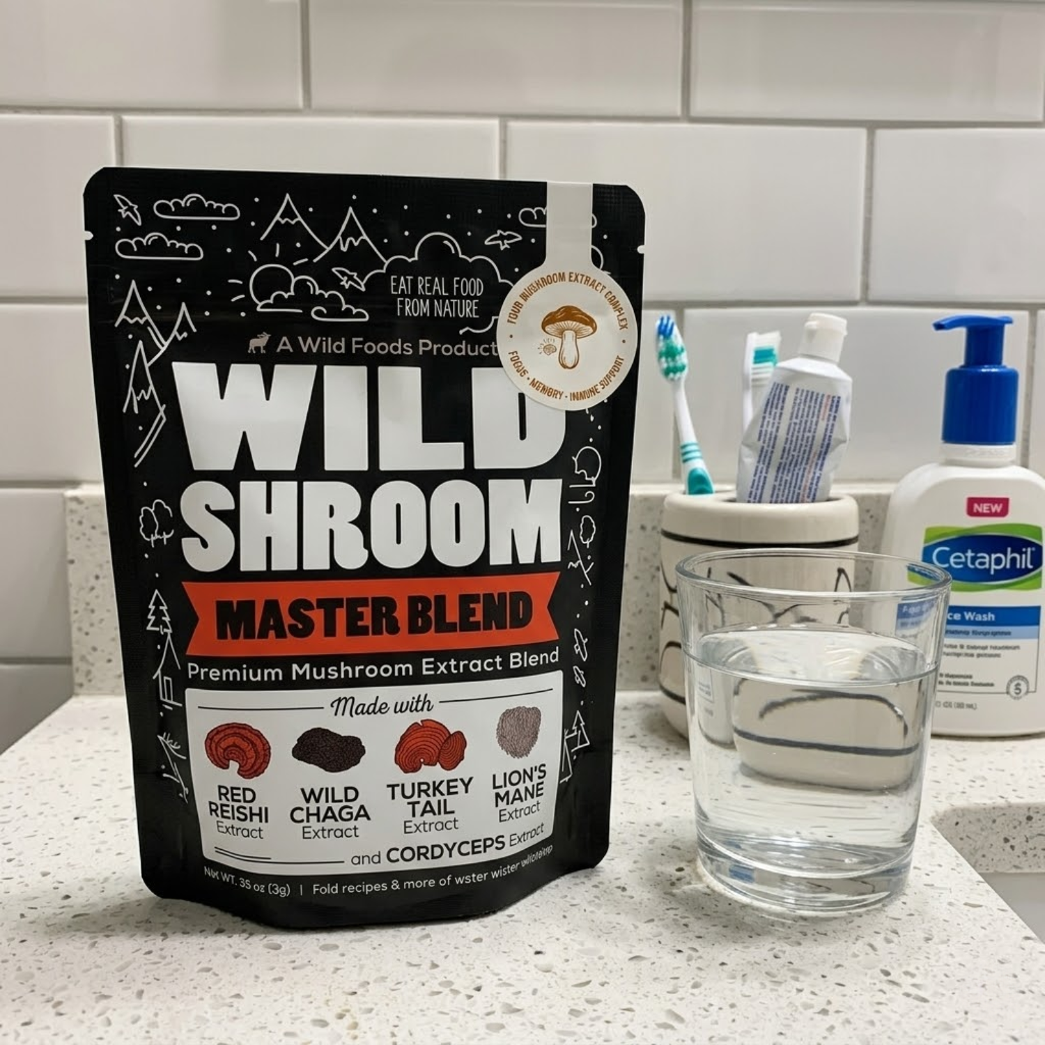 A pouch of Wild Shroom Master Blend mushroom extract on a bathroom counter next to a glass of water.