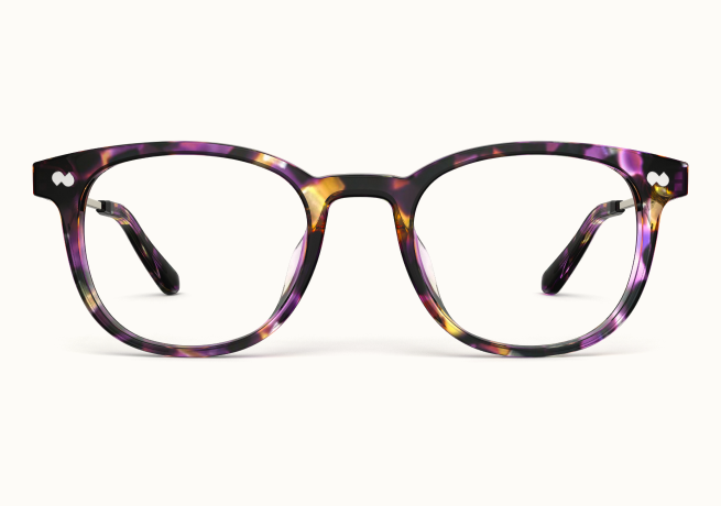 A pair of eyeglasses with round lenses and purple, yellow, and black tortoiseshell frames against a white background.