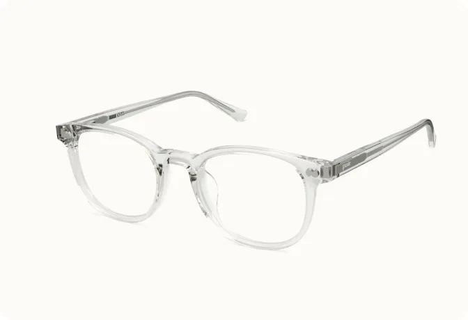 A pair of clear-framed eyeglasses with rounded lenses shown at an angle on a white background.