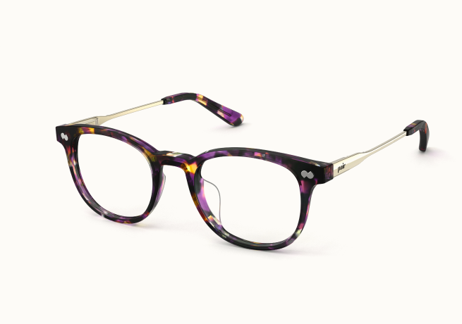A pair of eyeglasses with purple, yellow, and black patterned frames and thin, light gold arms.