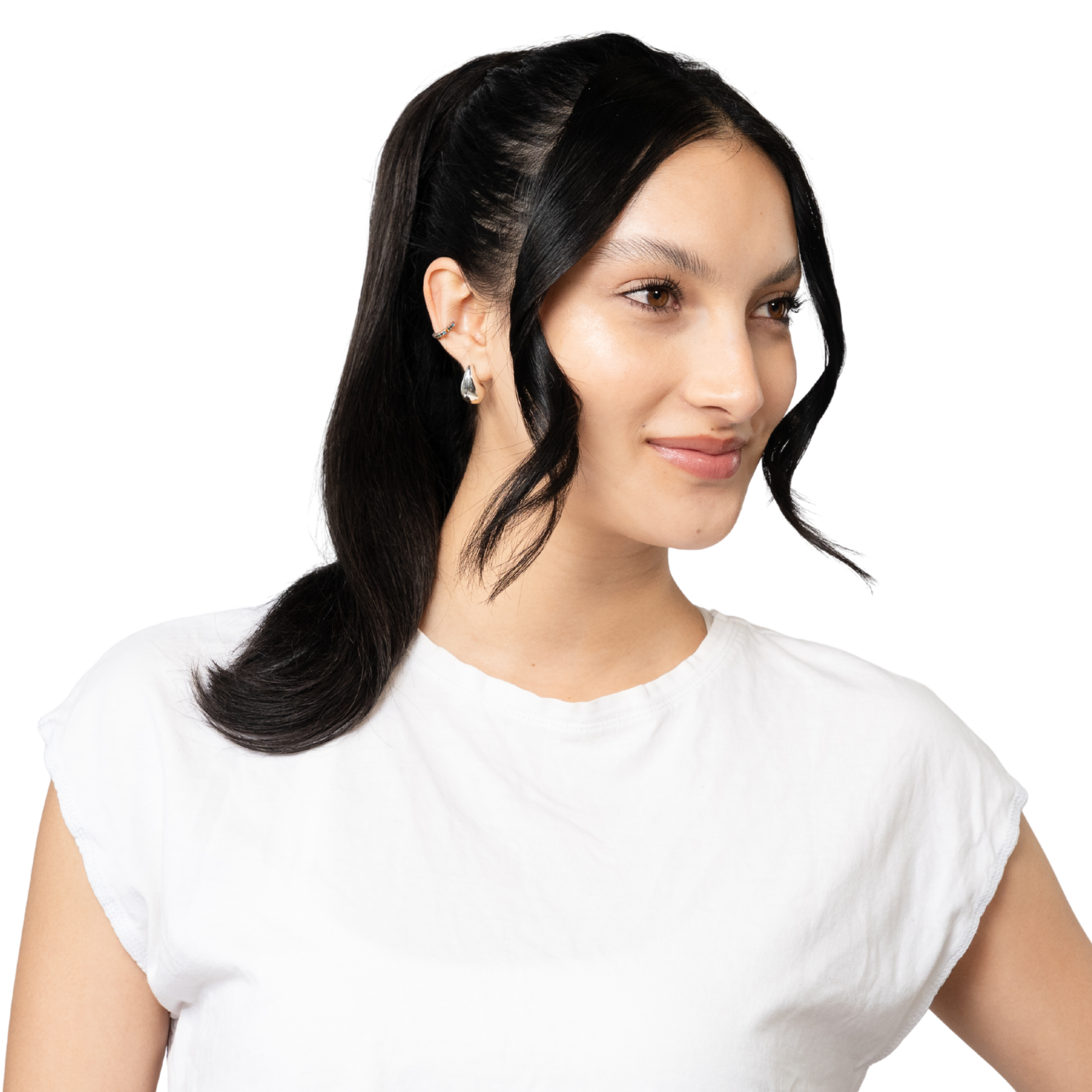 woman with dark hair in a styled ponytail wearing a white t shirt