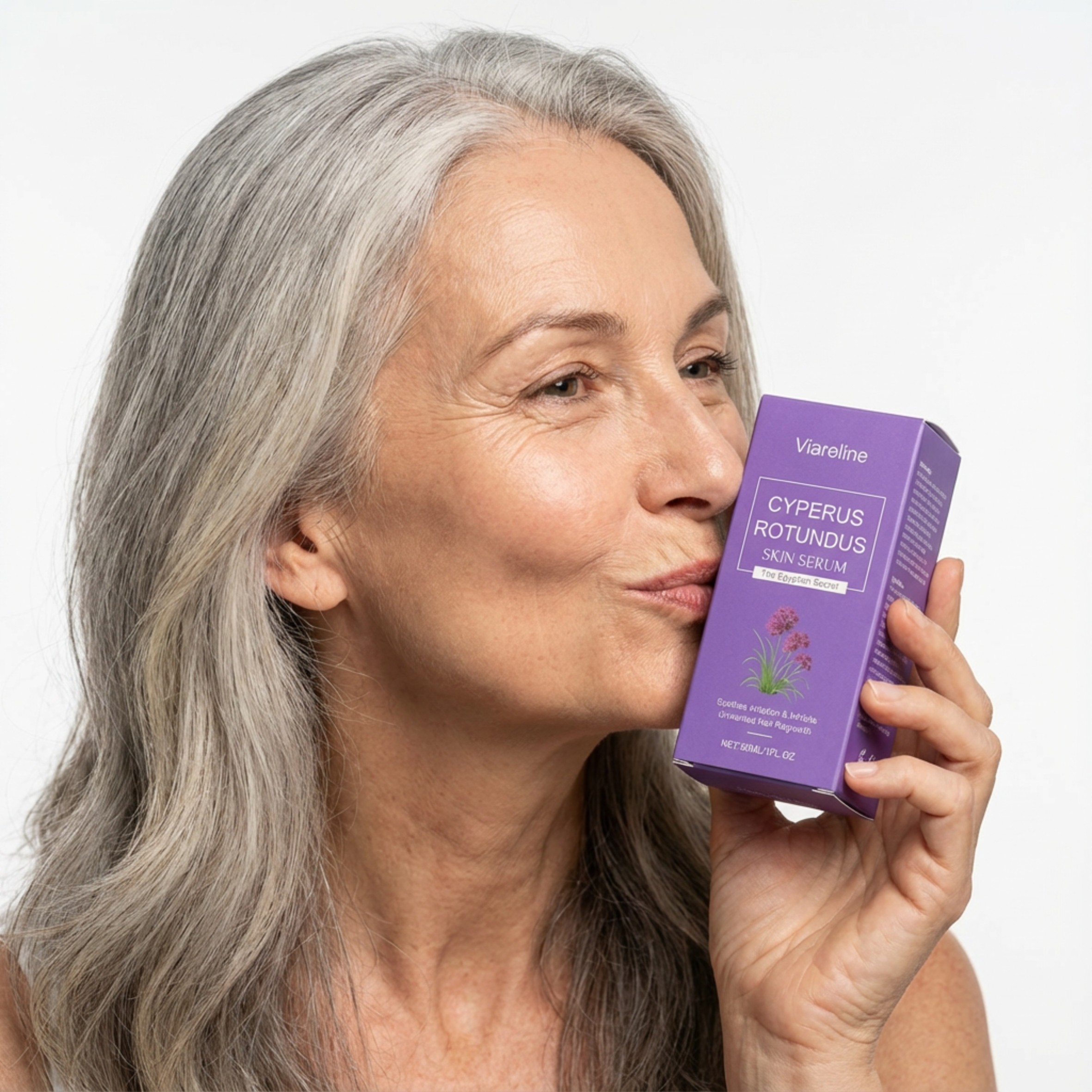 Woman with gray hair holding a purple skincare box.