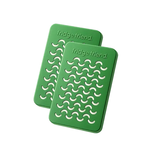 Two green rectangular 'fridge friend' pads with a wavy cutout pattern on a white background.