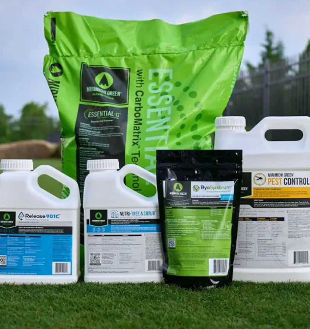 Various garden products and fertilizers displayed on grass.