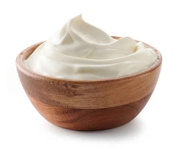 A wooden bowl filled with thick, creamy yogurt.